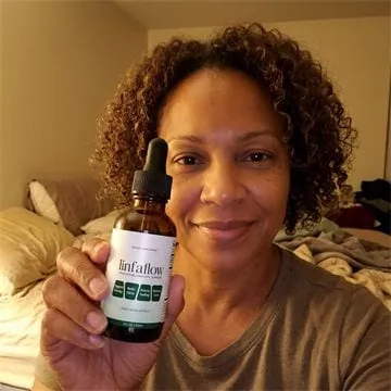 Linfaflow customer photo 1 — a verified buyer holding the 2 fl oz dropper bottle
