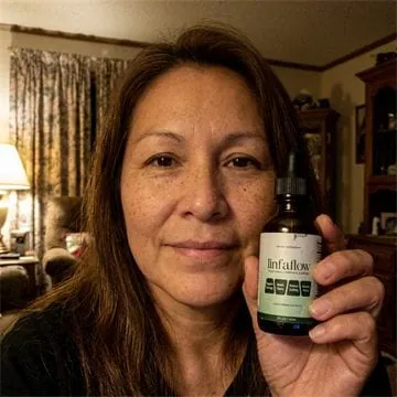 Linfaflow customer photo 5 — a verified buyer holding the 2 fl oz dropper bottle
